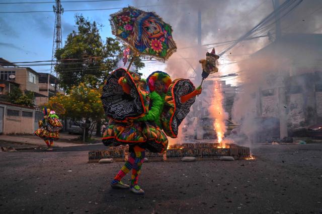 A member of Dito e Feito bate-bola street carnival group parades at Iraja neighbourhood, in the suburbs of Rio de Janeiro, Brazil on February 14, 2026. (Photo by MAURO PIMENTEL / AFP)