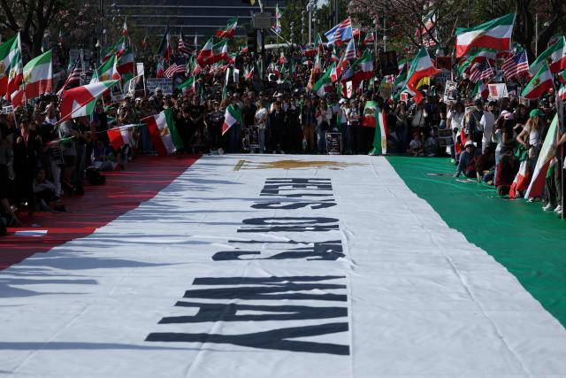 Demonstrators rally in solidarity with the Iranian protest movement in Los Angeles on February 14, 2026. The exiled son of Iran's last shah said he was ready to lead the country to a "secular democratic future" at a rally in Munich on Saturday, after US President Donald Trump said a change of power would be the "best thing". (Photo by Patrick T. Fallon / AFP)