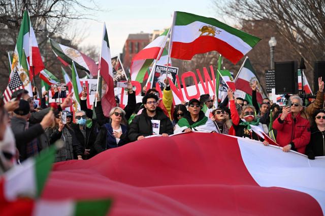 Demonstrators take part in a march in support of the people of Iran by members of the American-Iranian community in Washington, DC, on February 14, 2026. The demonstration comes after the bloody crackdown on protesters last month, while US President Donald Trump has been massing warships in the Middle East and declared Friday that a change of government in Iran would be the "best thing that could happen". (Photo by ROBERTO SCHMIDT / AFP)