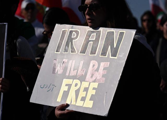 Demonstrators take part in a march in support of the people of Iran by members of the American-Iranian community in Washington, DC, on February 14, 2026. The demonstration comes after the bloody crackdown on protesters last month, while US President Donald Trump has been massing warships in the Middle East and declared Friday that a change of government in Iran would be the "best thing that could happen". (Photo by ROBERTO SCHMIDT / AFP)