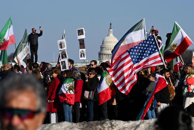 Demonstrators take part in a march in support of the people of Iran by members of the American-Iranian community in Washington, DC, on February 14, 2026. The demonstration comes after the bloody crackdown on protesters last month, while US President Donald Trump has been massing warships in the Middle East and declared Friday that a change of government in Iran would be the "best thing that could happen". (Photo by ROBERTO SCHMIDT / AFP)