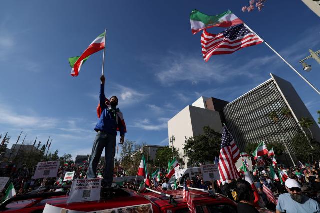 Demonstrators take part in a march in support of the people of Iran by members of the American-Iranian community in Los Angeles on February 14, 2026. The demonstration comes after the bloody crackdown on protesters last month, while US President Donald Trump has been massing warships in the Middle East and declared Friday that a change of government in Iran would be the "best thing that could happen". (Photo by Patrick T. Fallon / AFP)