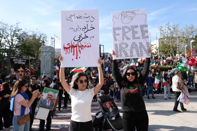 Demonstrators take part in a march in support of the people of Iran by members of the American-Iranian community in Los Angeles on February 14, 2026. The demonstration comes after the bloody crackdown on protesters last month, while US President Donald Trump has been massing warships in the Middle East and declared Friday that a change of government in Iran would be the "best thing that could happen". (Photo by Patrick T. Fallon / AFP)