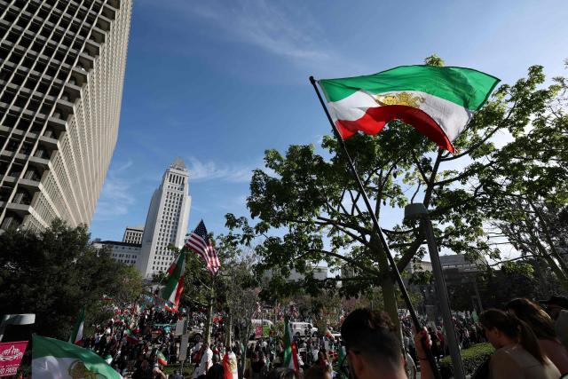 Demonstrators take part in a march in support of the people of Iran by members of the American-Iranian community in Los Angeles on February 14, 2026. The demonstration comes after the bloody crackdown on protesters last month, while US President Donald Trump has been massing warships in the Middle East and declared Friday that a change of government in Iran would be the "best thing that could happen". (Photo by Patrick T. Fallon / AFP)