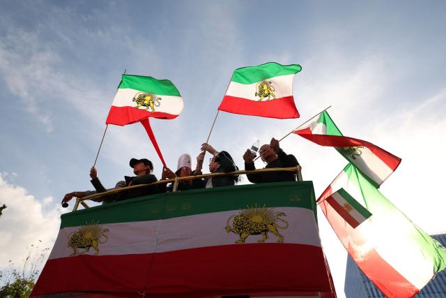 Demonstrators take part in a march in support of the people of Iran by members of the American-Iranian community in Los Angeles on February 14, 2026. The demonstration comes after the bloody crackdown on protesters last month, while US President Donald Trump has been massing warships in the Middle East and declared Friday that a change of government in Iran would be the "best thing that could happen". (Photo by Patrick T. Fallon / AFP)