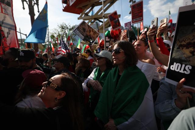 Demonstrators rally in solidarity with the Iranian protest movement in Los Angeles on February 14, 2026. The exiled son of Iran's last shah said he was ready to lead the country to a "secular democratic future" at a rally in Munich on Saturday, after US President Donald Trump said a change of power would be the "best thing". (Photo by Patrick T. Fallon / AFP)