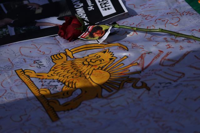 A sign featuring the Iranian lion from the pre-Islamic revolution of 1979 is seen during a march in support of the people of Iran by members of the American-Iranian community in in Los Angeles on February 14, 2026. The demonstration comes after the bloody crackdown on protesters last month, while US President Donald Trump has been massing warships in the Middle East and declared Friday that a change of government in Iran would be the "best thing that could happen". (Photo by Patrick T. Fallon / AFP)