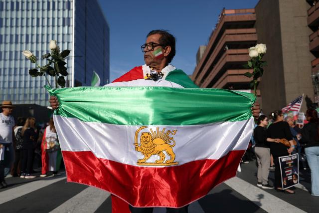 Demonstrators take part in a march in support of the people of Iran by members of the American-Iranian community in in Los Angeles on February 14, 2026. The demonstration comes after the bloody crackdown on protesters last month, while US President Donald Trump has been massing warships in the Middle East and declared Friday that a change of government in Iran would be the "best thing that could happen". (Photo by Patrick T. Fallon / AFP)