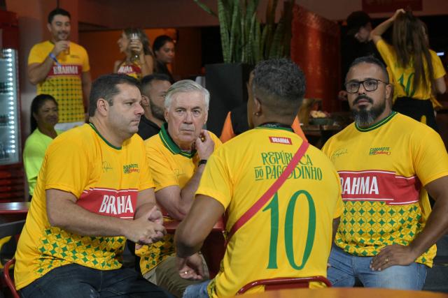 Brazil's Italian head coach Carlo Ancelotti (C) sits at a VIP zone during the second night of carnival parade in the Sambadrome in Sao Paulo, Brazil, on February 14, 2026. (Photo by NELSON ALMEIDA / AFP)