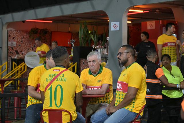 Brazil's Italian head coach Carlo Ancelotti (C) sits at a VIP zone during the second night of carnival parade in the Sambadrome in Sao Paulo, Brazil, on February 14, 2026. (Photo by NELSON ALMEIDA / AFP)