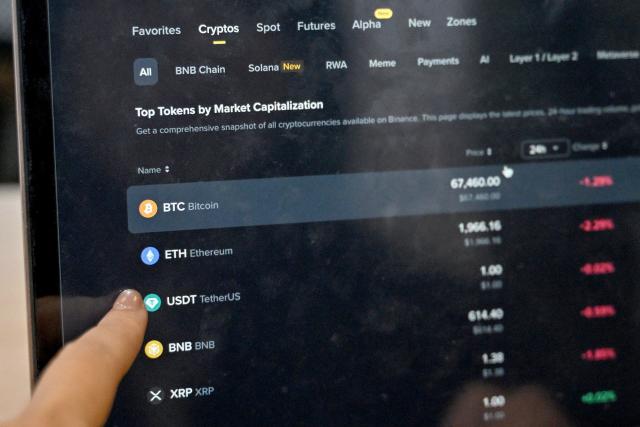 This photo taken on February 12, 2026 shows a Vietnamese cryptocurrency investor looking at the latest cryptocurrencies values on a laptop in Hanoi. As a first-year computer science student in Hanoi, Hoang Le started trading crypto from his university dorm room, egged on by his gamer friends who were making a killing, and at one point his digital holdings swelled to $200,000 -- around 50 times the average annual income in Vietnam. But they crashed to zero when the bottom fell out of bitcoin and other cryptocurrencies in recent months. (Photo by Nhac NGUYEN / AFP) / To go with 'VIETNAM-ECONOMY-CRYPTO,FOCUS' by Lam NGUYEN