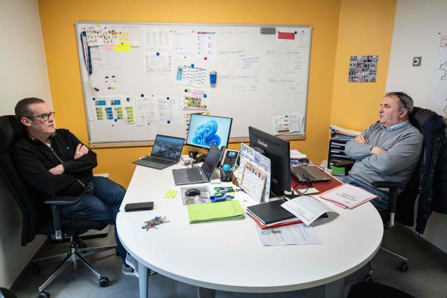 Mayors Arnaud Pageaud (R) and Jerome Squelard (L) work at the city hall of Teillé, western France, on February 10, 2026. They share their office, their days, and above all their role: in the small commune of Teillé, in Loire-Atlantique department, western France, two mayors are in charge. Pleased with their arrangement, they are jointly seeking a new term in the municipal elections. (Photo by Sebastien Salom-Gomis / AFP)