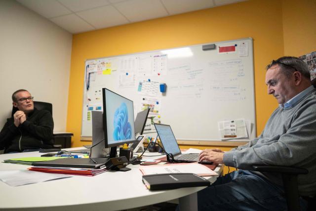 Mayors Arnaud Pageaud (R) and Jerome Squelard (L) work at the city hall of Teillé, western France, on February 10, 2026. They share their office, their days, and above all their role: in the small commune of Teillé, in Loire-Atlantique department, western France, two mayors are in charge. Pleased with their arrangement, they are jointly seeking a new term in the municipal elections. (Photo by Sebastien Salom-Gomis / AFP)
