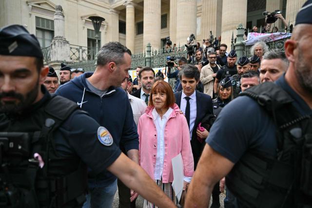 (FILES) Gisele Pelicot (C), followed by her lawyer Stephane Babonneau leaves the courthouse after the appeal trial of the Mazan rape case at the Nimes courthouse in Nimes, southern France, on October 9, 2025. It is undoubtedly the most eagerly awaited book of the year: in her memoirs, to be published on February 17, 2026 Gisele Pelicot tells for the first time the rapes organised by her ex-husband and the historic trial in Avignon, which made her a leading figure in the fight against sexual violence. (Photo by Christophe Simon / AFP)
