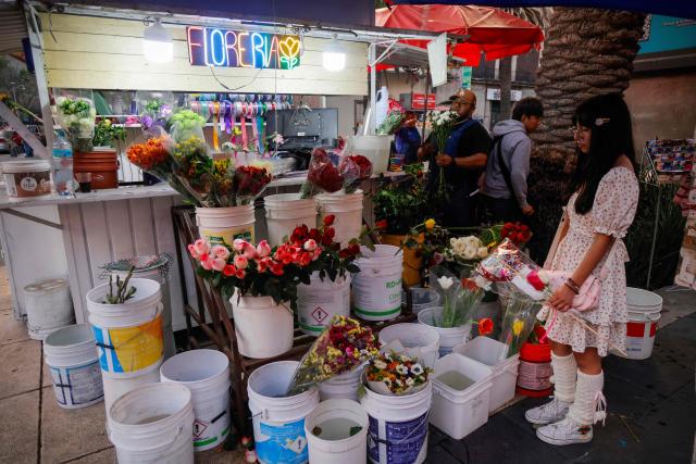 A young woman buys flowers on Valentine's Day in Mexico City on February 14, 2026. (Photo by Rodrigo OROPEZA / AFP)