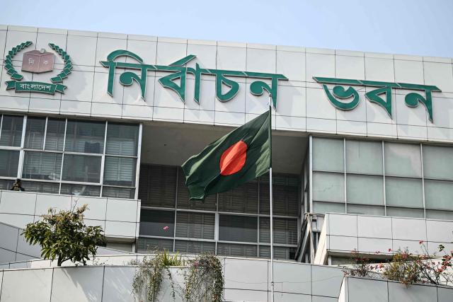 Bangladesh's national flag flutters at the Election Commission (EC) building in Dhaka on February 15, 2026. (Photo by Sajjad HUSSAIN / AFP)