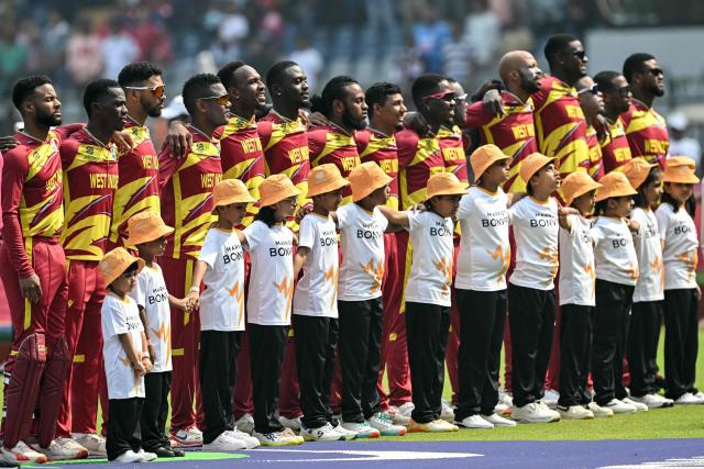 West Indies' players stand for the national anthem during the 2026 ICC Men's T20 Cricket World Cup group stage match between Nepal and West Indies at the Wankhede Stadium in Mumbai on February 15, 2026. (Photo by Indranil MUKHERJEE / AFP)