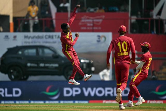 West Indies' Akeal Hosein (L) celebrates with teammates after taking the wicket of Nepal's Kushal Bhurtel during the 2026 ICC Men's T20 Cricket World Cup group stage match between Nepal and West Indies at the Wankhede Stadium in Mumbai on February 15, 2026. (Photo by Indranil MUKHERJEE / AFP)