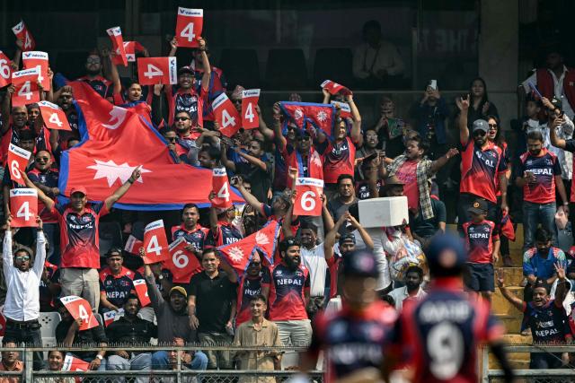 Nepal fans cheer from the stands during the 2026 ICC Men's T20 Cricket World Cup group stage match between Nepal and West Indies at the Wankhede Stadium in Mumbai on February 15, 2026. (Photo by Indranil MUKHERJEE / AFP)