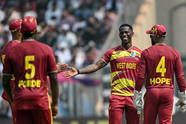 West Indies' Shamar Joseph (2R) celebrates with teammates after taking the wicket of Nepal's Lokesh Bam during the 2026 ICC Men's T20 Cricket World Cup group stage match between Nepal and West Indies at the Wankhede Stadium in Mumbai on February 15, 2026. (Photo by Indranil MUKHERJEE / AFP)