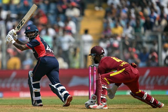 Nepal's Dipendra Singh Airee (L) watches the ball after playing a shot during the 2026 ICC Men's T20 Cricket World Cup group stage match between Nepal and West Indies at the Wankhede Stadium in Mumbai on February 15, 2026. (Photo by Indranil MUKHERJEE / AFP)