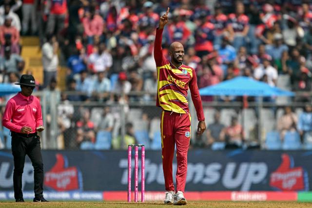 West Indies' Roston Chase celebrates after taking the wicket of Nepal's Gulsan Jha during the 2026 ICC Men's T20 Cricket World Cup group stage match between Nepal and West Indies at the Wankhede Stadium in Mumbai on February 15, 2026. (Photo by Indranil MUKHERJEE / AFP)