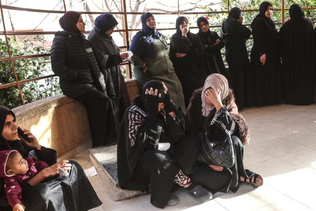 Palestinians displaced from their homes destroyed by Israeli military strikes, gather as they mourn during the funeral of several Palestinians killed in an overnight Israeli strike, according to medics at Nasser Hospital in Khan Yunis, in the southern Gaza Strip on February 15, 2026. The Palestinian president called on February 14, 2026, for the removal of "all obstacles" he said Israel has imposed on implementing phase two of the Gaza ceasefire. (Photo by Bashar Taleb / AFP)