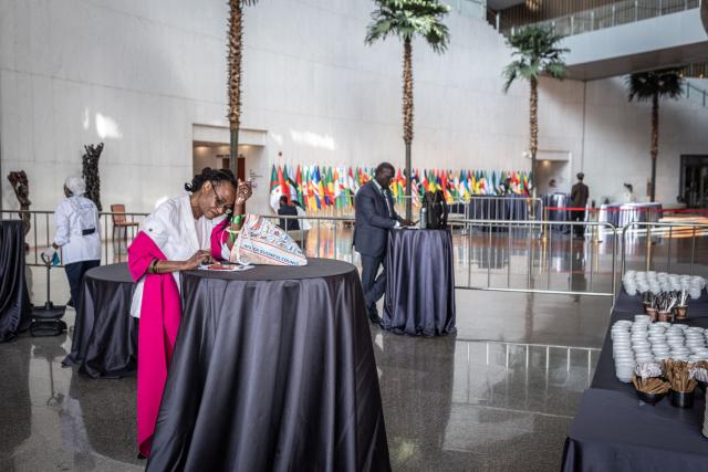 Delegates wait inside the African Union Headquarters ahead of meetings and bilateral talks during the 39th Ordinary Session of the Assembly of the African Union at the AU Headquarters in Addis Ababa on February 15, 2026. (Photo by Marco Simoncelli / AFP)