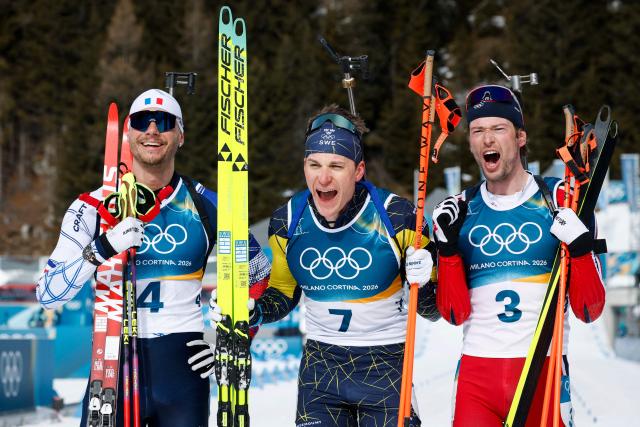 (From L) France's Emilien Jacquelin, Sweden's Martin Ponsiluoma and Norway's Sturla Holm Laegreid pose after crossing the finish line during the men's biathlon 12,5km pursuit event during the Milano Cortina 2026 Winter Olympic Games at the Anterselva Biathlon Arena (Sudtirol Arena) in Anterselva (Val Pusteria) on February 15, 2026. (Photo by Odd ANDERSEN / AFP)