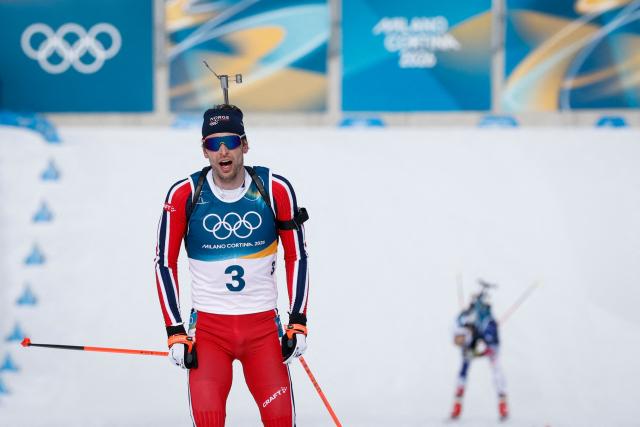 Norway's Sturla Holm Laegreid reacts while crossing the finish line during the men's biathlon 12,5km pursuit event during the Milano Cortina 2026 Winter Olympic Games at the Anterselva Biathlon Arena (Sudtirol Arena) in Anterselva (Val Pusteria) on February 15, 2026. (Photo by Odd ANDERSEN / AFP)
