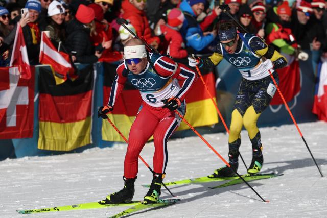 Norway's Johannes Dale-Skjevdal (L) and Sweden's Martin Ponsiluoma (R) ski during the men's biathlon 12,5km pursuit event during the Milano Cortina 2026 Winter Olympic Games at the Anterselva Biathlon Arena (Sudtirol Arena) in Anterselva (Val Pusteria) on February 15, 2026. (Photo by FRANCK FIFE / AFP)