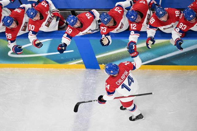 Czech Republic's #14 Filip Chlapik celebrates with teammates after scoring his team's first goal during men's preliminary round Group A Ice Hockey match between Switzerland and Czech Republic at the Milano Santagiulia Ice Hockey Arena during the Milano Cortina 2026 Winter Olympic Games in Milan, on February 15, 2026. (Photo by Alexander NEMENOV / AFP)