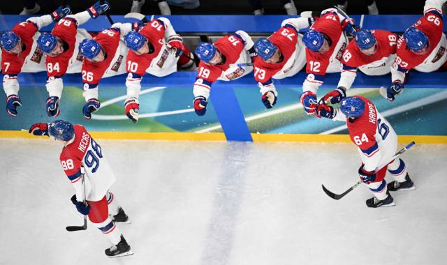 Czech Republic's #98 Martin Necas and Czech Republic's #64 David Kampf celebrate with team mates after Czech Republic's #14 Filip Chlapik scored his team's first goal during men's preliminary round Group A Ice Hockey match between Switzerland and Czech Republic at the Milano Santagiulia Ice Hockey Arena during the Milano Cortina 2026 Winter Olympic Games in Milan, on February 15, 2026. (Photo by Alexander NEMENOV / AFP)