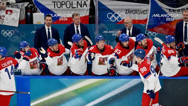Czech Republic's #14 Filip Chlapik (L) and Czech Republic's #98 Martin Necas celebrate with teammates after Chlapik scores his team's first goal during men's preliminary round Group A Ice Hockey match between Switzerland and Czech Republic at the Milano Santagiulia Ice Hockey Arena during the Milano Cortina 2026 Winter Olympic Games in Milan, on February 15, 2026. (Photo by Alexander NEMENOV / AFP)
