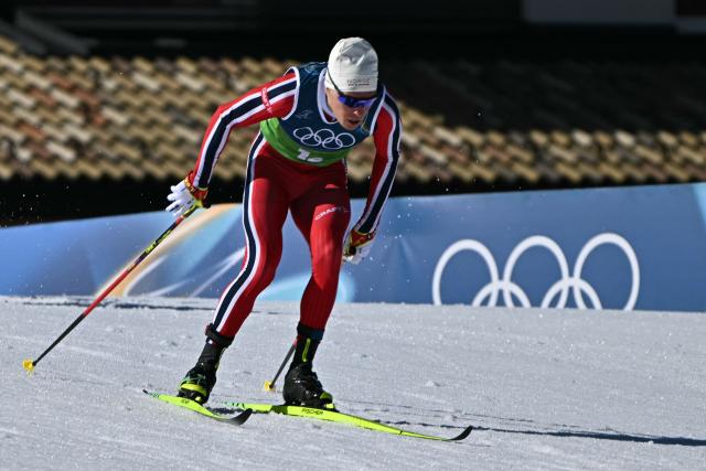 Norway's Martin Loewstroem Nyenget competes during the cross-country men's 4 x 7,5km relay event of the Milano Cortina 2026 Winter Olympic Games at Tesero Cross-Country Skiing Stadium in Lago di Tesero (Val di Fiemme), on February 15, 2026. (Photo by Javier SORIANO / AFP)
