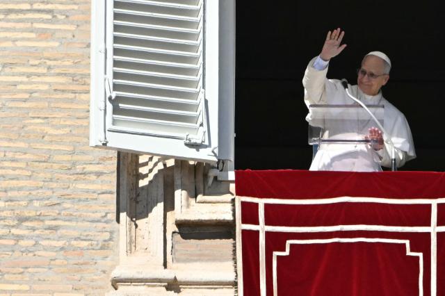 Pope Leo XIV waves to the crowd from the window of the apostolic palace overlooking St. Peter's square during the Angelus prayer in the Vatican on February 15, 2026. (Photo by Andreas SOLARO / AFP)