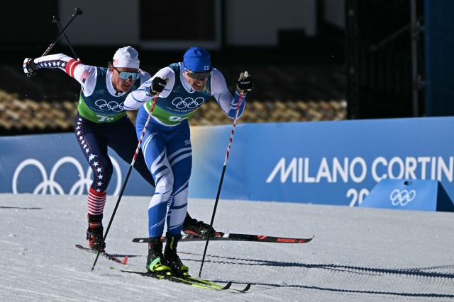 USA's Gus Schumacher (L) and Finland's Iivo Niskanen compete during the cross-country men's 4 x 7,5km relay event of the Milano Cortina 2026 Winter Olympic Games at Tesero Cross-Country Skiing Stadium in Lago di Tesero (Val di Fiemme), on February 15, 2026. (Photo by Javier SORIANO / AFP)