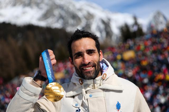 Gold medallist France's Martin Fourcade poses with his medal following the medal reallocation ceremony of the Vancouver 2010 biathlon men's 15km mass start during the Milano Cortina 2026 Winter Olympic Games at the Anterselva Biathlon Arena (Sudtirol Arena) in Anterselva (Val Pusteria) on February 15, 2026. (Photo by Franck FIFE / AFP)