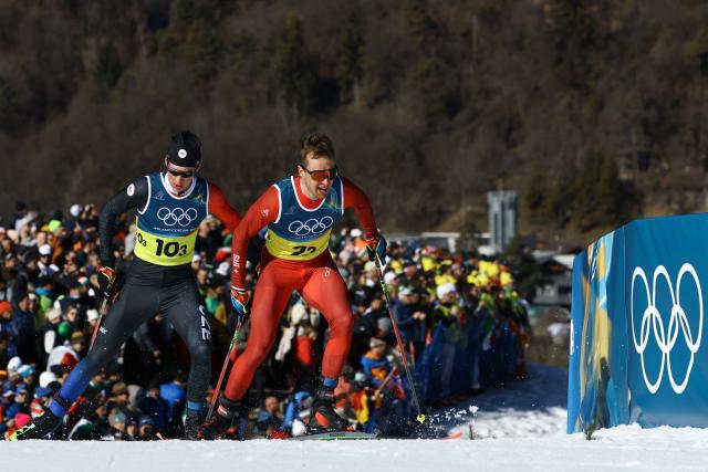Czech Republic's Matyas Bauer (L) and Switzerland's Beda Klee compete during the cross-country men's 4 x 7,5km relay event of the Milano Cortina 2026 Winter Olympic Games at Tesero Cross-Country Skiing Stadium in Lago di Tesero (Val di Fiemme), on February 15, 2026. (Photo by Anne-Christine POUJOULAT / AFP)