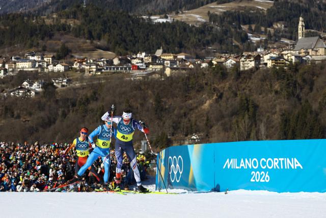 Canada's Remi Drolet (L), Italy's Martino Carollo and France's Mathis Desloges compete during the cross-country men's 4 x 7,5km relay event of the Milano Cortina 2026 Winter Olympic Games at Tesero Cross-Country Skiing Stadium in Lago di Tesero (Val di Fiemme), on February 15, 2026. (Photo by Anne-Christine POUJOULAT / AFP)