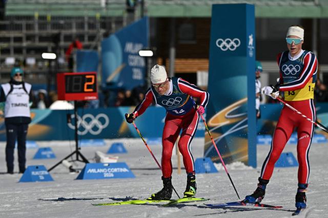 Norway's Johannes Hoesflot Klaebo (L) starts to compete next to Norway's Einar Hedegart during the cross-country men's 4 x 7,5km relay event of the Milano Cortina 2026 Winter Olympic Games at Tesero Cross-Country Skiing Stadium in Lago di Tesero (Val di Fiemme), on February 15, 2026. (Photo by Javier SORIANO / AFP)