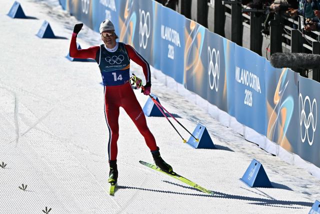 Norway's Johannes Hoesflot Klaebo celebrates as he skies to the finish line to win the cross-country men's 4 x 7,5km relay event of the Milano Cortina 2026 Winter Olympic Games at Tesero Cross-Country Skiing Stadium in Lago di Tesero (Val di Fiemme), on February 15, 2026. (Photo by Javier SORIANO / AFP)