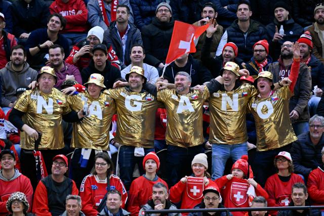 Czech Republic fans wear golden shirts forming the name 'Nagano' during men's preliminary round Group A Ice Hockey match between Switzerland and Czech Republic at the Milano Santagiulia Ice Hockey Arena during the Milano Cortina 2026 Winter Olympic Games in Milan, on February 15, 2026. In the 1998 Winter Olympics ice hockey final in Nagano, Japan, the Czech Republic beat Russia 1-0 (Photo by Alexander NEMENOV / AFP)