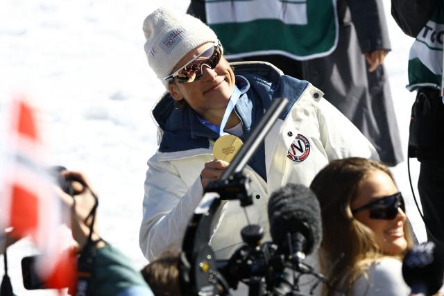 Gold medallist Norway's Johannes Hoesflot Klaebo celebrates with his medal after the cross-country men's 4 x 7,5km relay event of the Milano Cortina 2026 Winter Olympic Games at Tesero Cross-Country Skiing Stadium in Lago di Tesero (Val di Fiemme), on February 15, 2026. (Photo by Anne-Christine POUJOULAT / AFP)