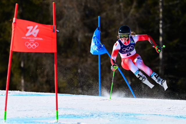 TOPSHOT - Switzerland's Camille Rast competes in the second run of the women's giant slalom event during the Milano Cortina 2026 Winter Olympic Games at the Tofane Alpine Skiing Centre in Cortina d’Ampezzo on February 15, 2026. (Photo by Stefano RELLANDINI / AFP)