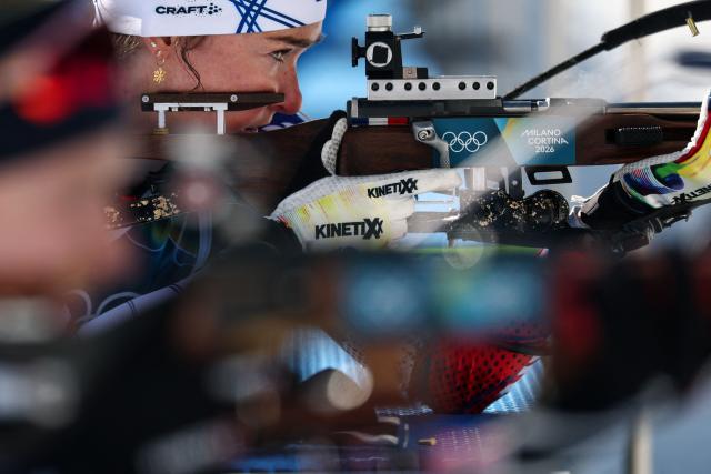 France's Lou Jeanmonnot (behind) warms up in the shooting range ahead of the women's biathlon 10km pursuit event during the Milano Cortina 2026 Winter Olympic Games at the Anterselva Biathlon Arena (Sudtirol Arena) in Anterselva (Val Pusteria) on February 15, 2026. (Photo by FRANCK FIFE / AFP)