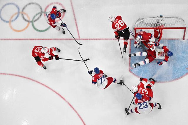 Czech Republic's #07 David Spacek (top) and Czech Republic's #73 Ondrej Kase (3L) vie for the puck with Switzerland's #13 Nico Hischier during men's preliminary round Group A Ice Hockey match between Switzerland and Czech Republic at the Milano Santagiulia Ice Hockey Arena during the Milano Cortina 2026 Winter Olympic Games in Milan, on February 15, 2026. (Photo by Alexander NEMENOV / AFP)
