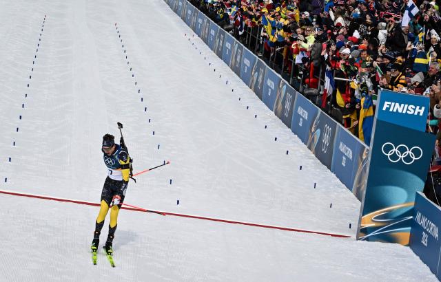 Sweden's Martin Ponsiluoma reacts while crossing the finish line during the men's biathlon 12,5km pursuit event during the Milano Cortina 2026 Winter Olympic Games at the Anterselva Biathlon Arena (Sudtirol Arena) in Anterselva (Val Pusteria) on February 15, 2026. (Photo by Franck FIFE / AFP)