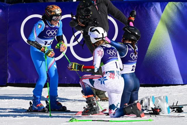 Bronze medallist Norway's Thea Louise Stjernesund (C) and silver medallist Sweden's Sara Hector (R) react as Italy's Federica Brignone (L) wins the gold medal in the  women's giant slalom event during the Milano Cortina 2026 Winter Olympic Games at the Tofane Alpine Skiing Centre in Cortina d’Ampezzo on February 15, 2026. (Photo by Stefano RELLANDINI / AFP)