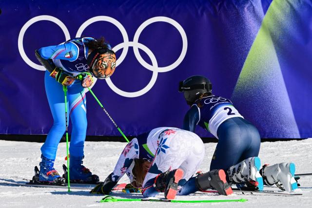 TOPSHOT - Tied silver medallists Norway's Thea Louise Stjernesund (C) and  Sweden's Sara Hector (R) react as Italy's Federica Brignone (L) wins the gold medal in the  women's giant slalom event during the Milano Cortina 2026 Winter Olympic Games at the Tofane Alpine Skiing Centre in Cortina d’Ampezzo on February 15, 2026. (Photo by Stefano RELLANDINI / AFP)